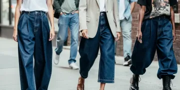 Models wearing wide-leg raw denim jeans in an urban fashion shoot, highlighting the fabric's texture.