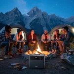 Campers enjoying evening with portable power station charging devices