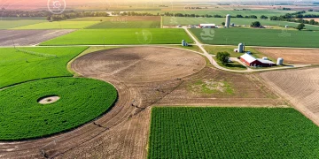 Diverse US farmlands under varying climate conditions, symbolizing climate change's agricultural impact.